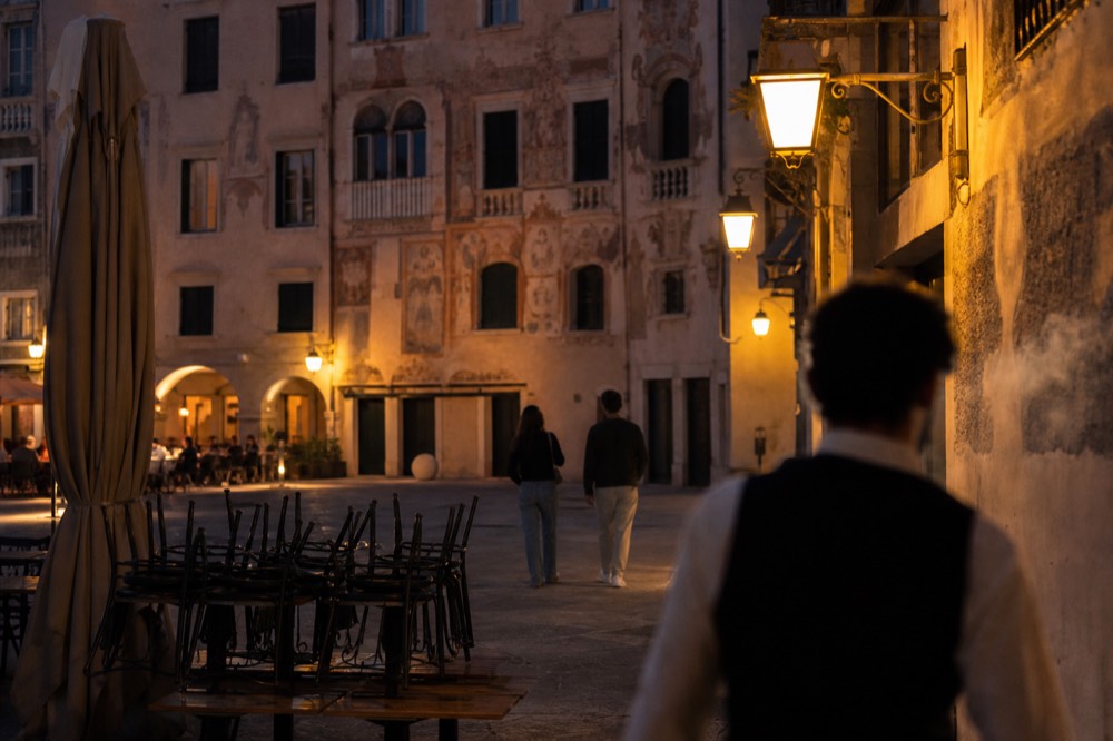 Lantern-lit Verona square with frescoed medieval facades in the evening, no text, no logos, no people